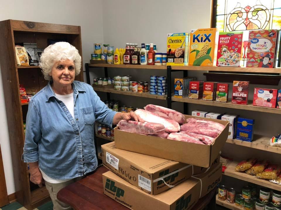 Bev standing by donation of pork loins